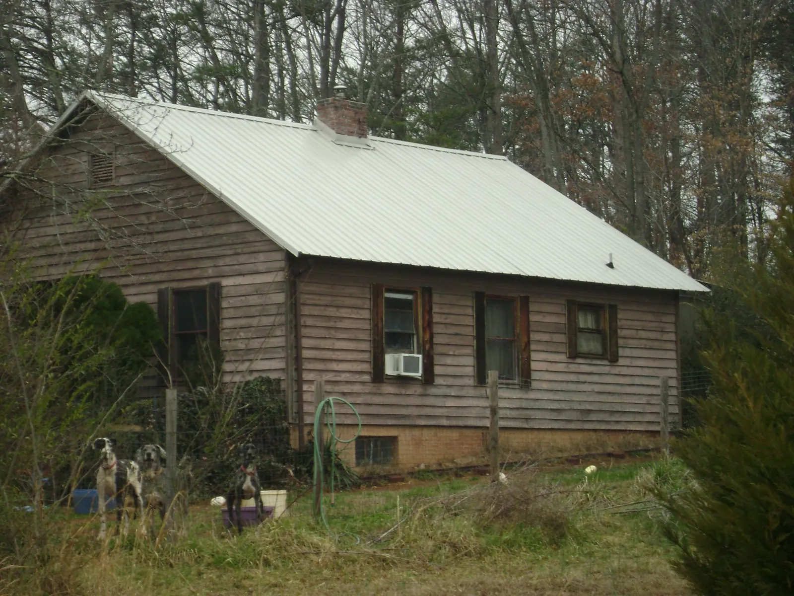 White metal roof on an old wood sided farmhouse, from a Metal Roof Installation job in Warrenton